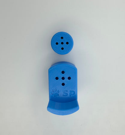 A single set of a 3D-printed Sniffy Prints pairing extension and Tiny Hide for K9 nosework in blue. The extension in the image is magnetic and designed to go over Sniffy Prints Tiny Hide. The extension features a curved base to hold a treat, multiple small holes for odor to pass through, and an embossed 'SP' logo with a paw print.