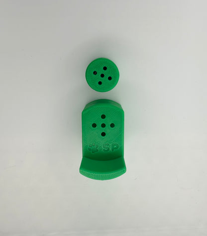 A single set of a 3D-printed Sniffy Prints pairing extension and Tiny Hide for K9 nosework in Green. The extension in the image is magnetic and designed to go over Sniffy Prints Tiny Hide. The extension features a curved base to hold a treat, multiple small holes for odor to pass through, and an embossed 'SP' logo with a paw print.