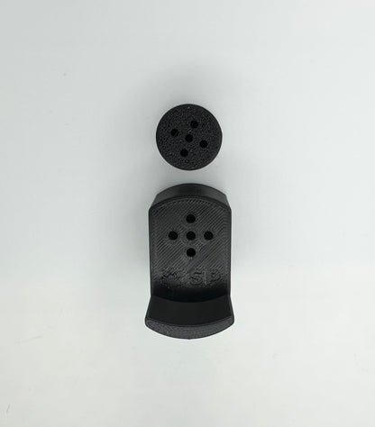 A single set of a 3D-printed Sniffy Prints pairing extension and Tiny Hide for K9 nosework in Black. The extension in the image is magnetic and designed to go over Sniffy Prints Tiny Hide. The extension features a curved base to hold a treat, multiple small holes for odor to pass through, and an embossed 'SP' logo with a paw print.