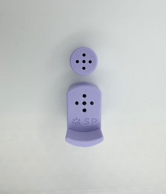 A single set of a 3D-printed Sniffy Prints pairing extension and Tiny Hide for K9 nosework in Periwinkle. The extension in the image is magnetic and designed to go over Sniffy Prints Tiny Hide. The extension features a curved base to hold a treat, multiple small holes for odor to pass through, and an embossed 'SP' logo with a paw print.