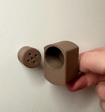 A single set of a 3D-printed Sniffy Prints pairing extension and Tiny Hide for K9 nosework in Brown. The extension in the image is magnetic and designed to go over Sniffy Prints Tiny Hide. The extension features a curved base to hold a treat, multiple small holes for odor to pass through, and an embossed 'SP' logo with a paw print.