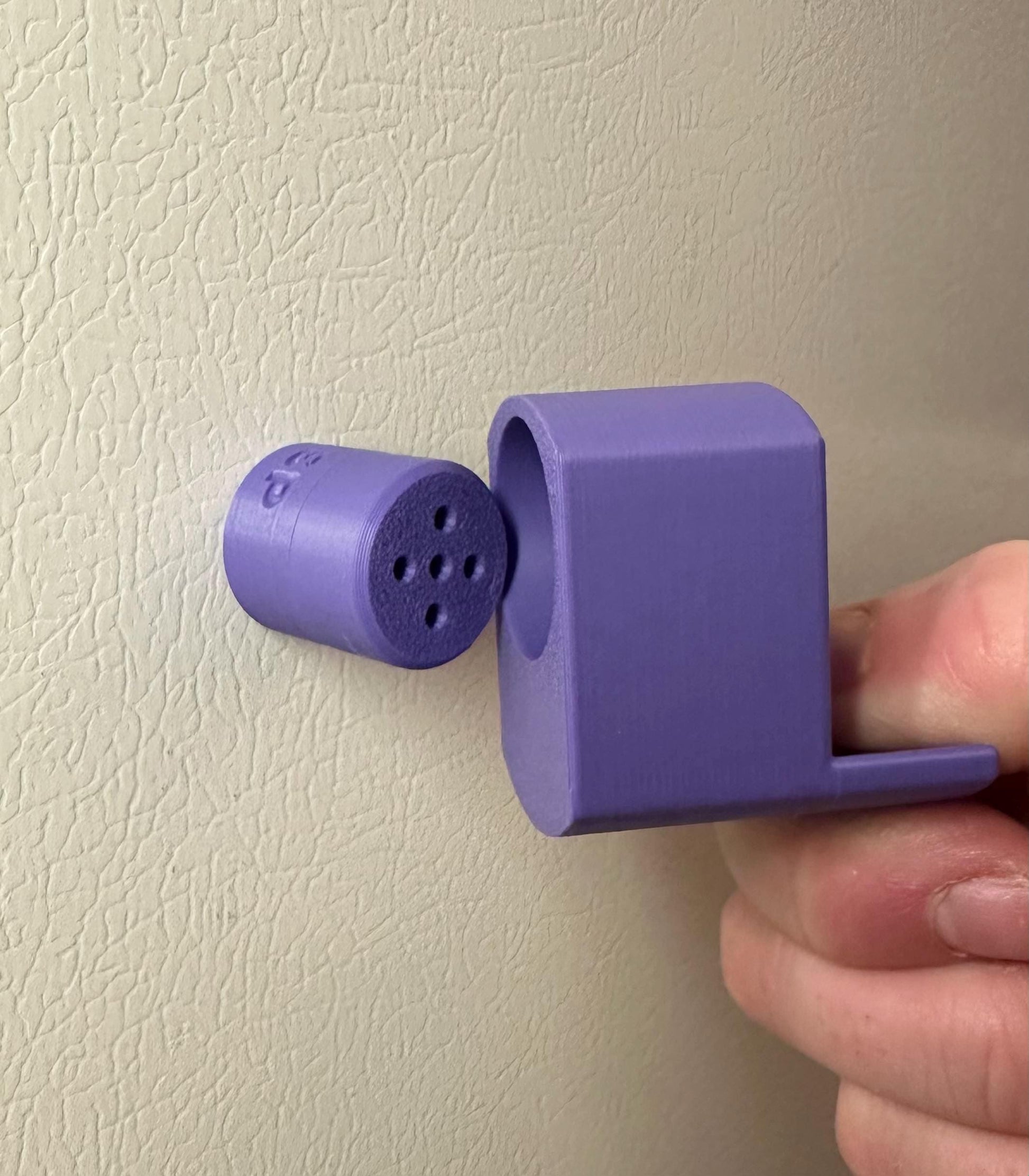 A single set of a 3D-printed Sniffy Prints pairing extension and Tiny Hide for K9 nosework in Purple. The extension in the image is magnetic and designed to go over Sniffy Prints Tiny Hide. The extension features a curved base to hold a treat, multiple small holes for odor to pass through, and an embossed 'SP' logo with a paw print.