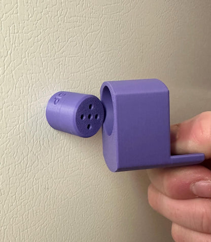 A single set of a 3D-printed Sniffy Prints pairing extension and Tiny Hide for K9 nosework in Purple. The extension in the image is magnetic and designed to go over Sniffy Prints Tiny Hide. The extension features a curved base to hold a treat, multiple small holes for odor to pass through, and an embossed 'SP' logo with a paw print.